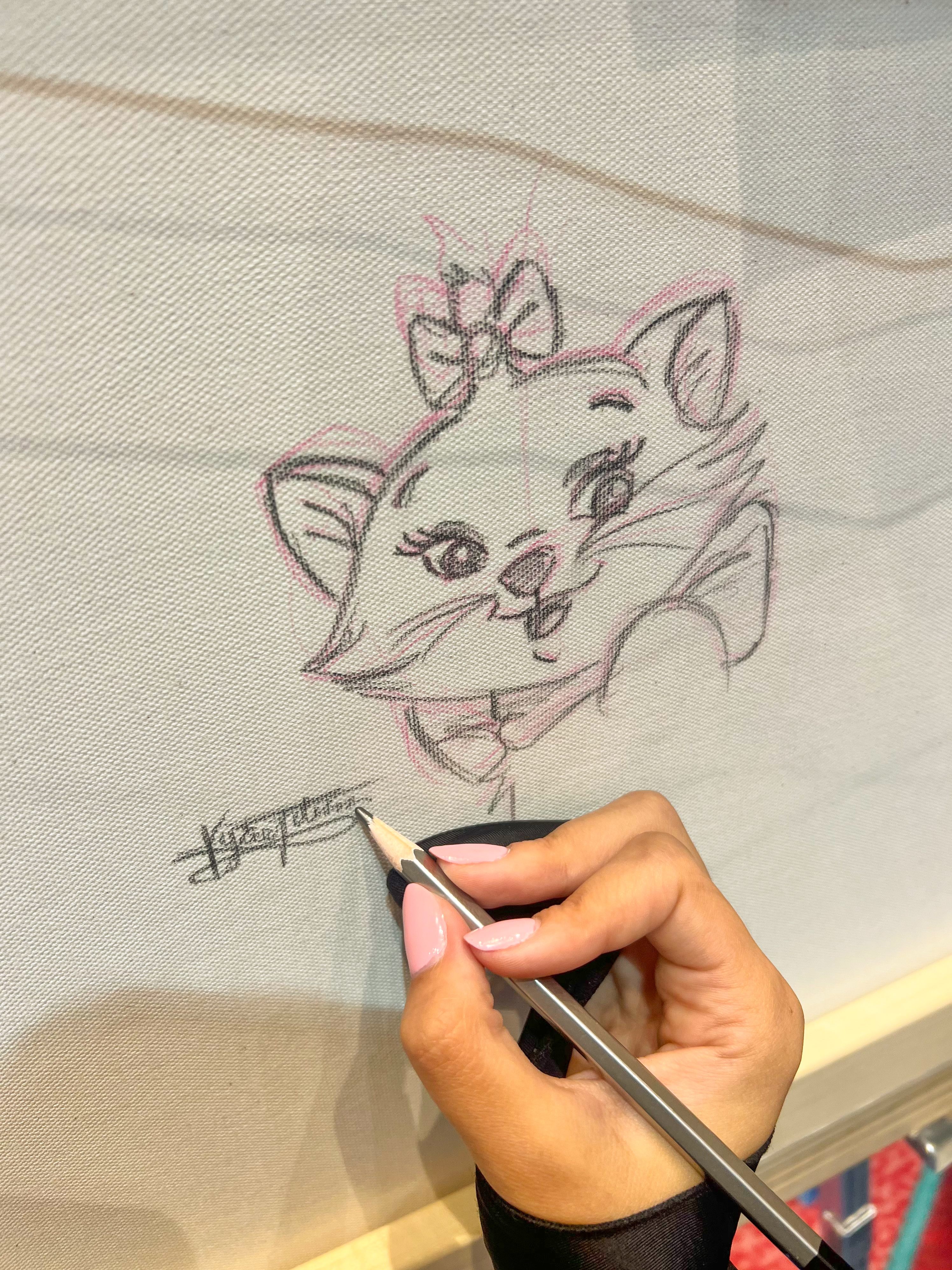 Kyree sketching Marie from The Aristocats with pencil