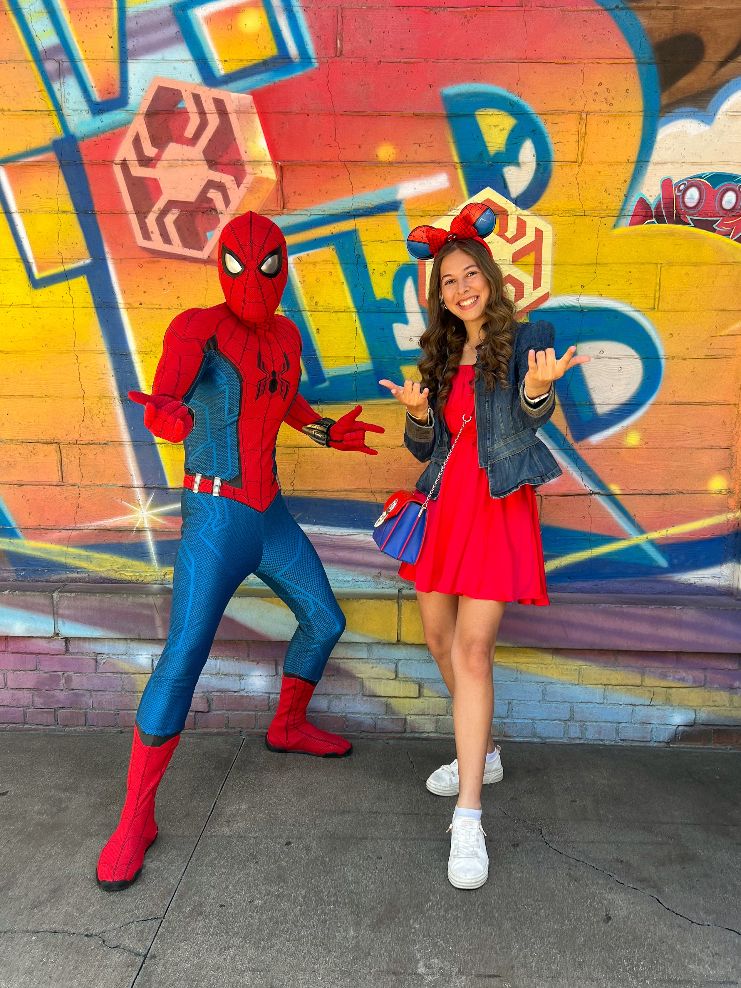 Kyree posing with Spider-Man character at Disney Parks